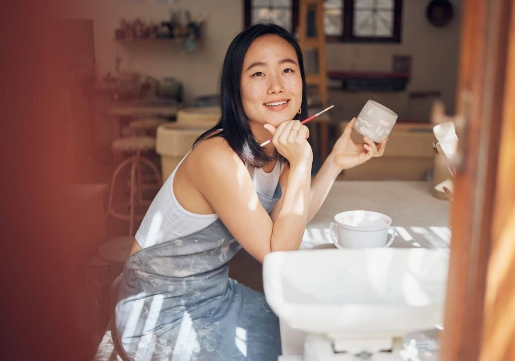 Woman painting pottery